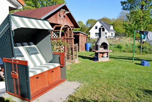 a backyard with a play house and a playground at Ferienhaus an der Granitz in Seerams