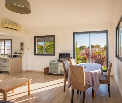 une cuisine et une salle à manger avec une table et des chaises dans l'établissement A 500m de la plage, à Hyères