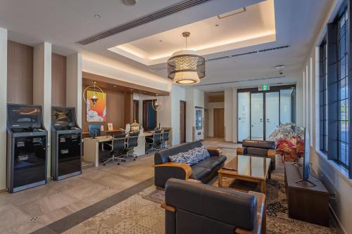 a living room with a couch and a table at Kariyushi LCH. Resort in Nago