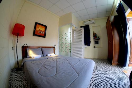 a bedroom with a bed and a red lamp in it at Trầm Homestay in Thôn An Hòa