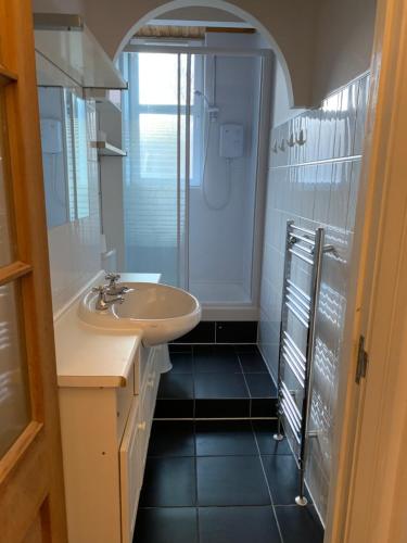 a bathroom with a sink and a shower at Edinburgh Capital Apartments - 49 Elbe Street in Edinburgh