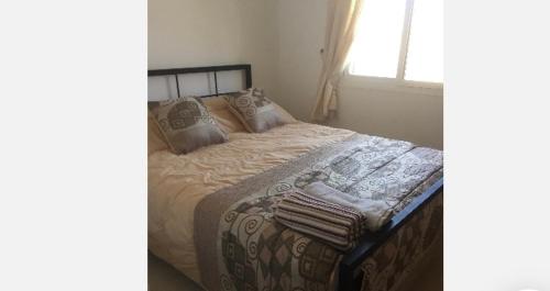 a bedroom with a bed with a blanket and a window at Calle Los Laureles, 36 Holiday Home in Mollina