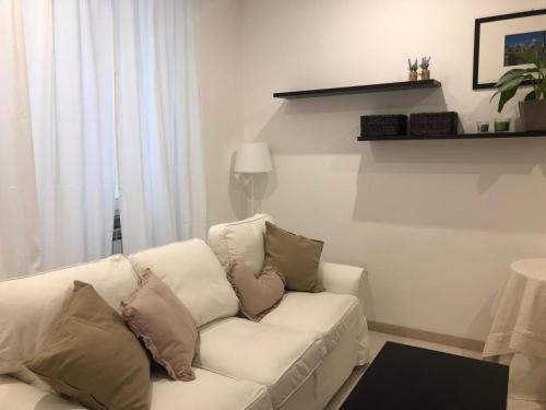 a white couch with pillows on it in a living room at PALAZZO MARCHETTI in Ancona