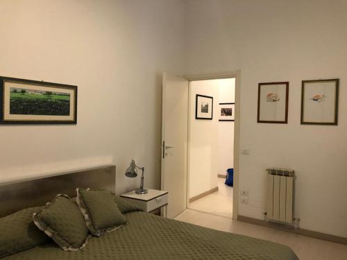 a bedroom with a bed and a door to a hallway at PALAZZO MARCHETTI in Ancona