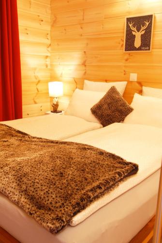 a bedroom with two beds with a blanket on them at Le cocon du Catogne proche Martigny Verbier - Netflix - in Les Valettes