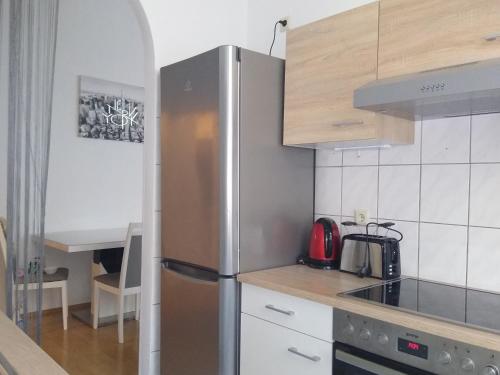 a kitchen with a stainless steel refrigerator in a kitchen at Spacious Central Apartment in Vienna