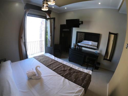 a bedroom with a bed with a swan on it at Hotel San Diego in Guanajuato