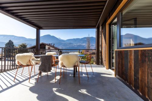 a patio with chairs and a table with a view of mountains at Innerbachlerhof - Gantkofel in Postal