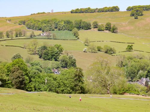 a view of a green field with trees and hills at Beresford Dale in Ashbourne