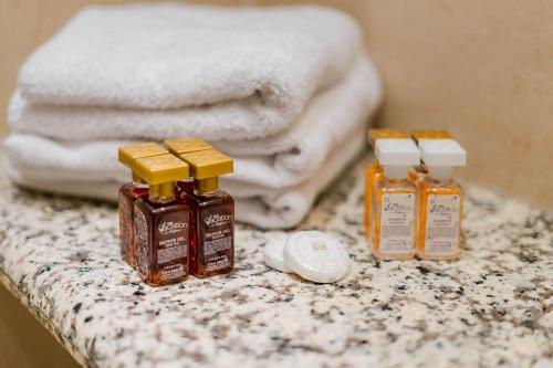 three bottles of essential oils on a counter with towels at ApartComplex Splendid in Saints Constantine and Helena