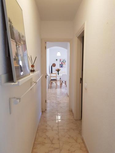 a hallway leading to a living room with a table at Alquilaencanarias- Medano Amanecer Cabezo Beach in El Médano