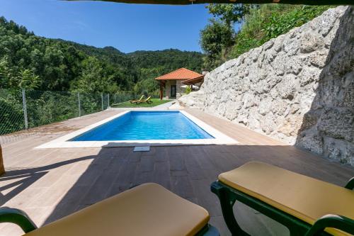 a view of a swimming pool from the deck of a house at Casa de Fundões - Gerês in Geres
