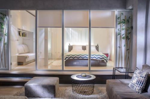 a bedroom with a bed inside of a glass wall at Apartment Cubo Maksimir 1 in Zagreb