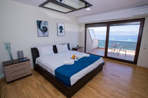 a bedroom with a bed with a view of the ocean at Park Diamond Apartments in Ohrid