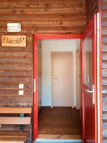 a hallway of a house with a red door at ZirkelsteinResort gGmbH in Schöna