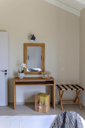 a bathroom with a wooden vanity with a mirror at Tree of Life in Valeriános
