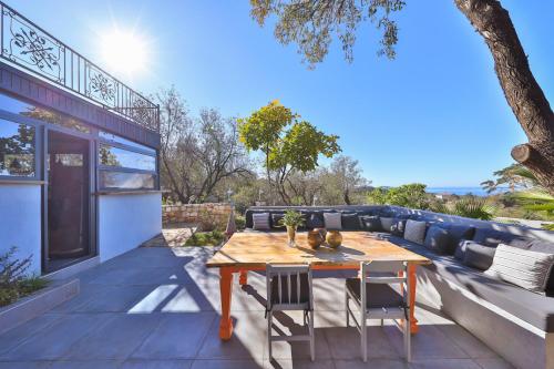a patio with a wooden table and chairs at Kale Lodge - Adult Only + 15 in Kas