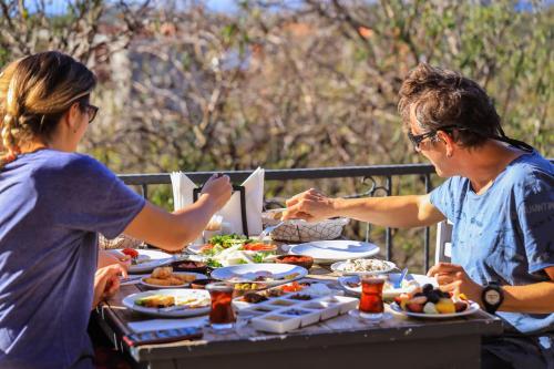 two women sitting at a table eating food at Kale Lodge - Adult Only + 15 in Kas