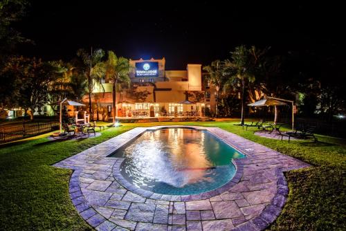 a swimming pool in a park at night at Town Lodge Polokwane in Polokwane