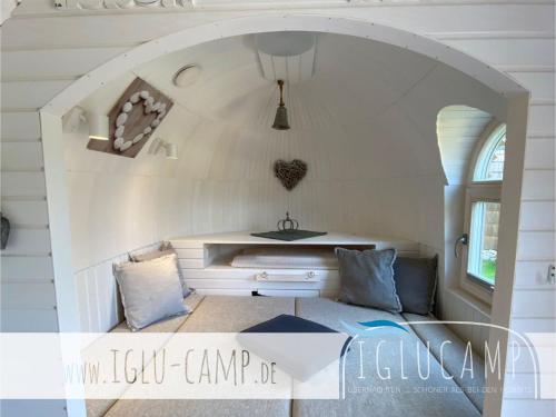 a living room with a couch and a table at Iglu Camp Heidewald in Sassenberg