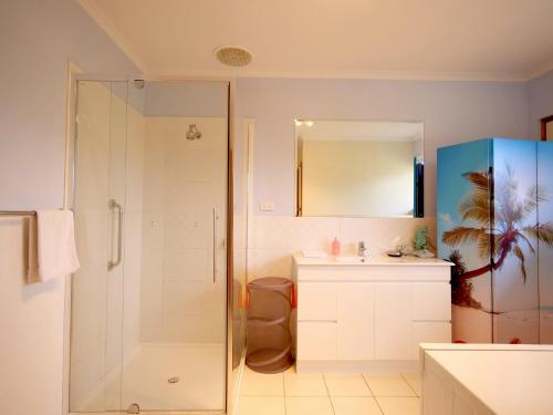 a bathroom with a shower and a sink at Salty Air Apartments Kingscote Kangaroo Island in Kingscote