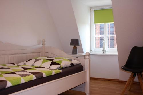 Un dormitorio con una cama y una ventana en Nikolaikirch-Hof, en Wismar