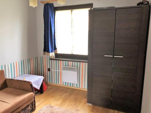 a large black cabinet in a room with a window at domek w centrum w Zawoi in Zawoja