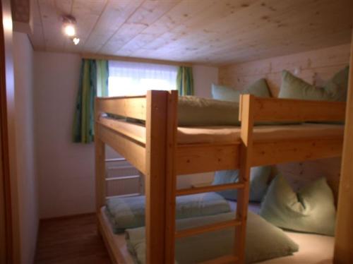 a bunk bed in a small room with a bunk bedutenewayangering at Dreimäderlhaus in Sankt Gallenkirch