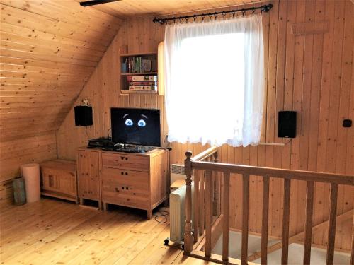 a room with a staircase and a television in a cabin at domek w centrum w Zawoi in Zawoja