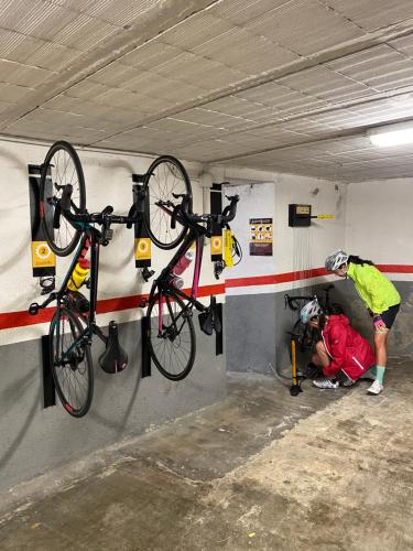 two bikes hanging on a wall in a garage at Apartaments Sant Antoni in Ribes de Freser