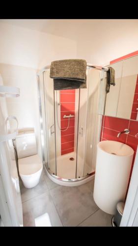 a small bathroom with a toilet and a sink at MICRO MAISON ROYAN CENTRE VILLE/PLAGE A PIED in Royan