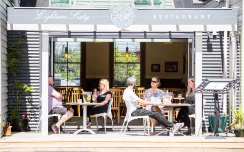 a group of people sitting at tables outside a restaurant at The Greytown Hotel in Greytown