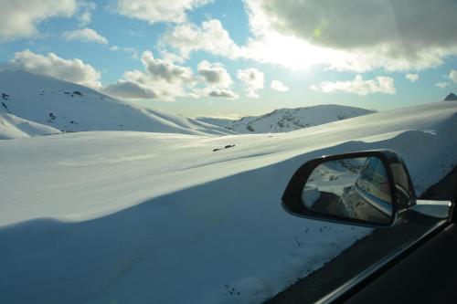 a side view mirror of a car in the snow at Hardanger Fjordtun PANORAMA cabin near the Hardangerfjord with fantastic fjordview, silence and nature in Herand