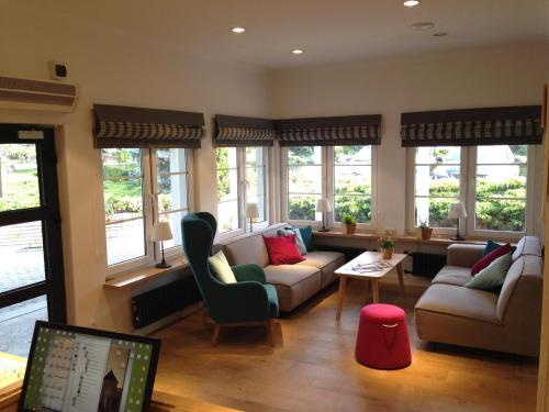 a living room with couches and a laptop computer at Hotel Camping Malta in Poznań