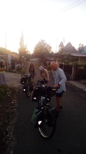 a group of people standing next to motorcycles on a street at D-Rima Homestay Ruteng in Ruteng