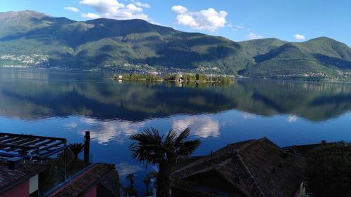 a view of a large body of water with mountains at Casa Eva in Ronco s/Ascona - Porto Ronco