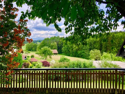 a wooden fence with a view of a garden at Ferienwohnung Fam. Lerch in Sankt Stefan ob Stainz