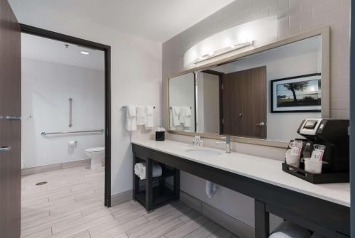 a bathroom with a sink and a large mirror at Comfort Suites Kennewick at Southridge in Kennewick