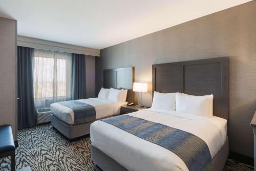 a hotel room with two beds and a window at Comfort Suites Kennewick at Southridge in Kennewick