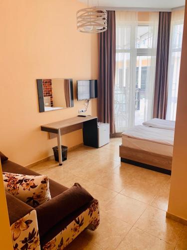 a bedroom with a bed and a desk in a room at Agora Studios in Plovdiv