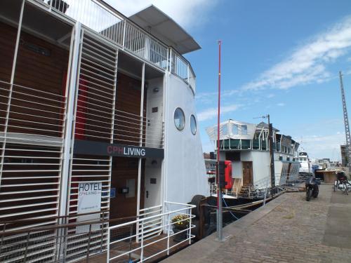 a boat is docked next to a building at Hotel CPH Living in Copenhagen