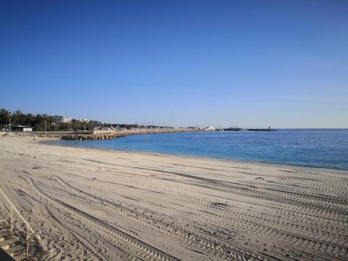a beach with tracks in the sand and water at APPARTEMENT CANNES MONTFLEURY in Cannes