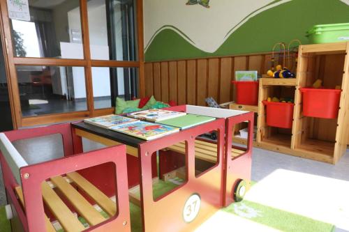 a play room with a table and two chairs at Jugendherberge Bad Malente in Malente