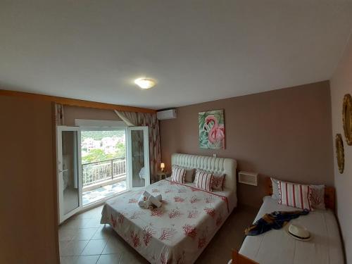 a bedroom with a bed and a window at Athanasia Rooms in Maries