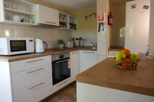 a kitchen with a bowl of fruit on a counter at EcoHouse Risan Studio in Risan