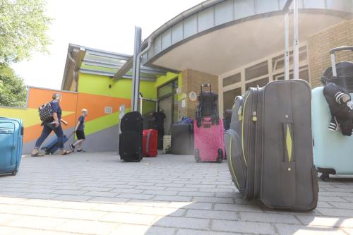 a bunch of luggage sitting outside of a building at Jugendherberge Bad Malente in Malente