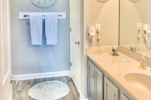 a bathroom with a sink and a mirror at Sterling Reef in Panama City Beach