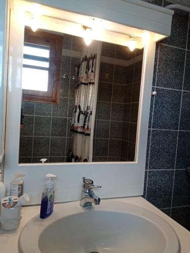 a bathroom with a sink and a mirror at Litochoro House with a View in Litochoro