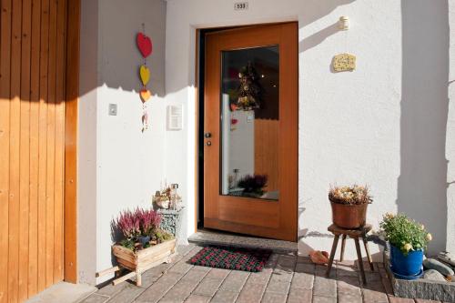 a front door of a house with potted plants at Wieser - Ferienwohnung für 2-3 Personen in Sent