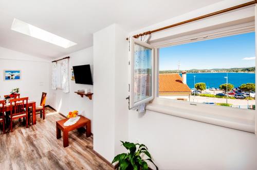 a room with a window and a dining room with a table at Casa Campus in Rovinj